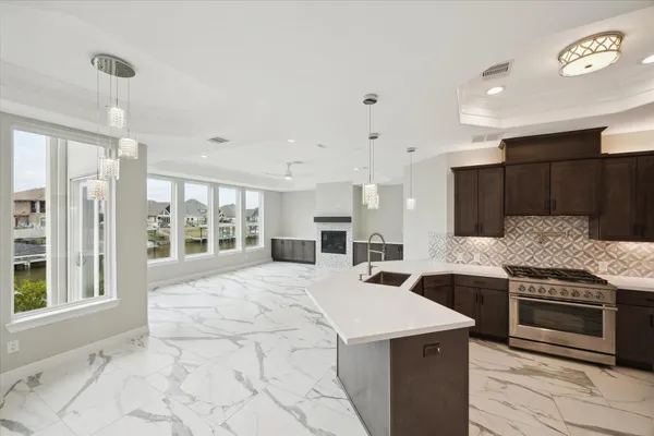 a kitchen with stainless steel appliances granite countertop a sink stove and refrigerator