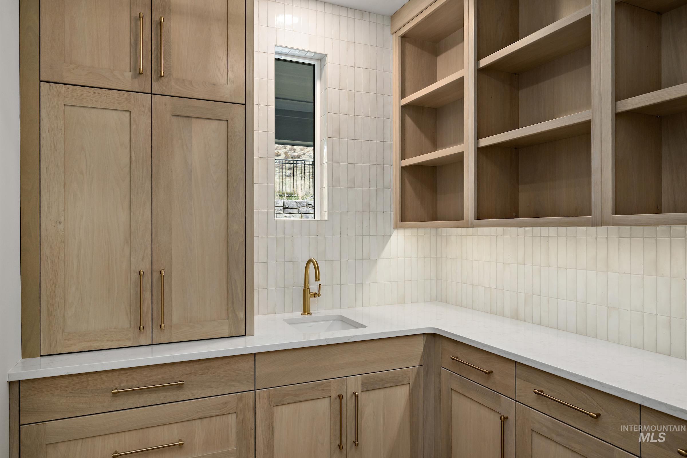 11708 North Rabbitbrush Way Boise, ID 83714 - Photo 14 of 33 Kitchen featuring light brown cabinets, light stone countertops, and tasteful backsplash