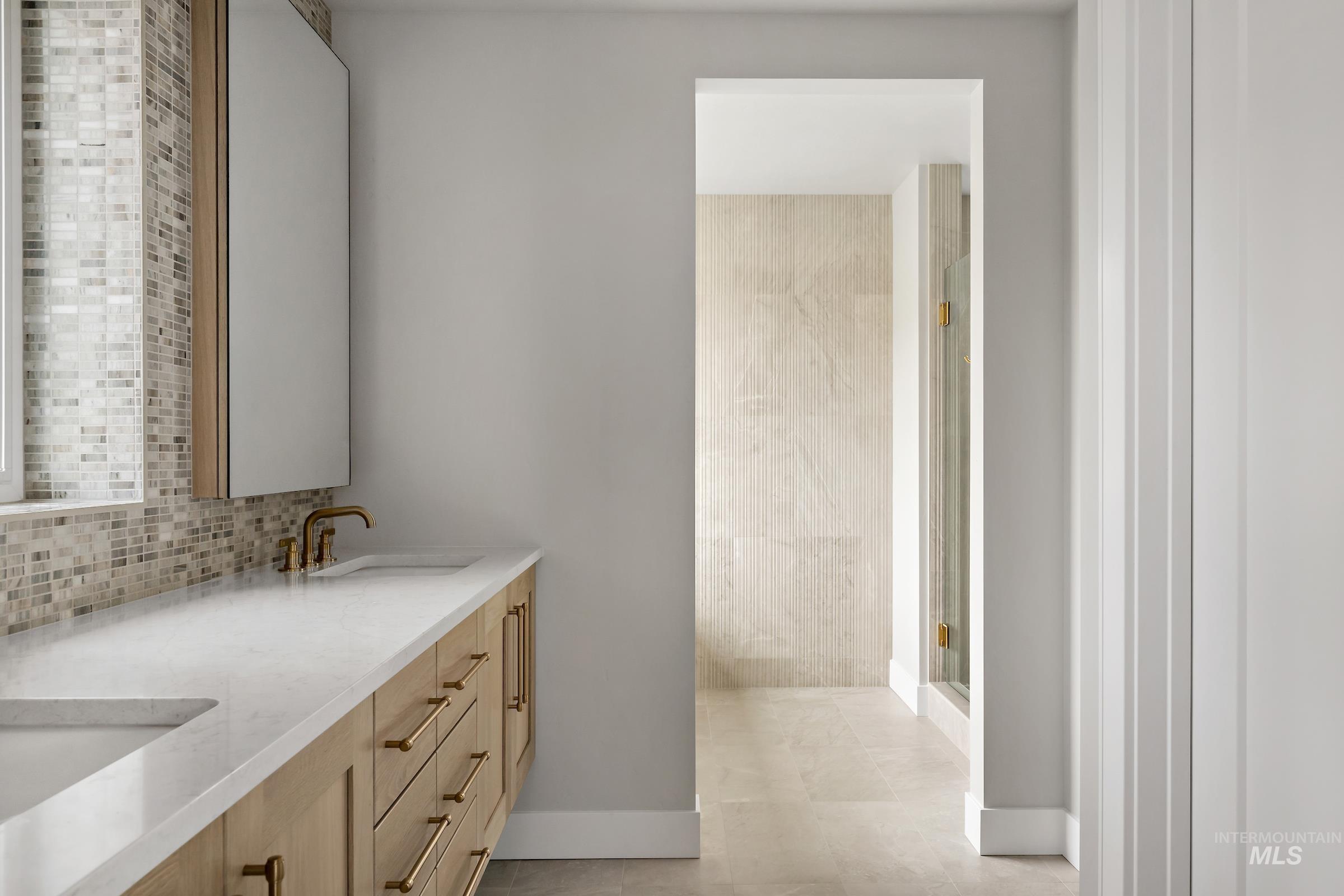 11708 North Rabbitbrush Way Boise, ID 83714 - Photo 18 of 33 Full bath with double vanity, a shower stall, and decorative backsplash