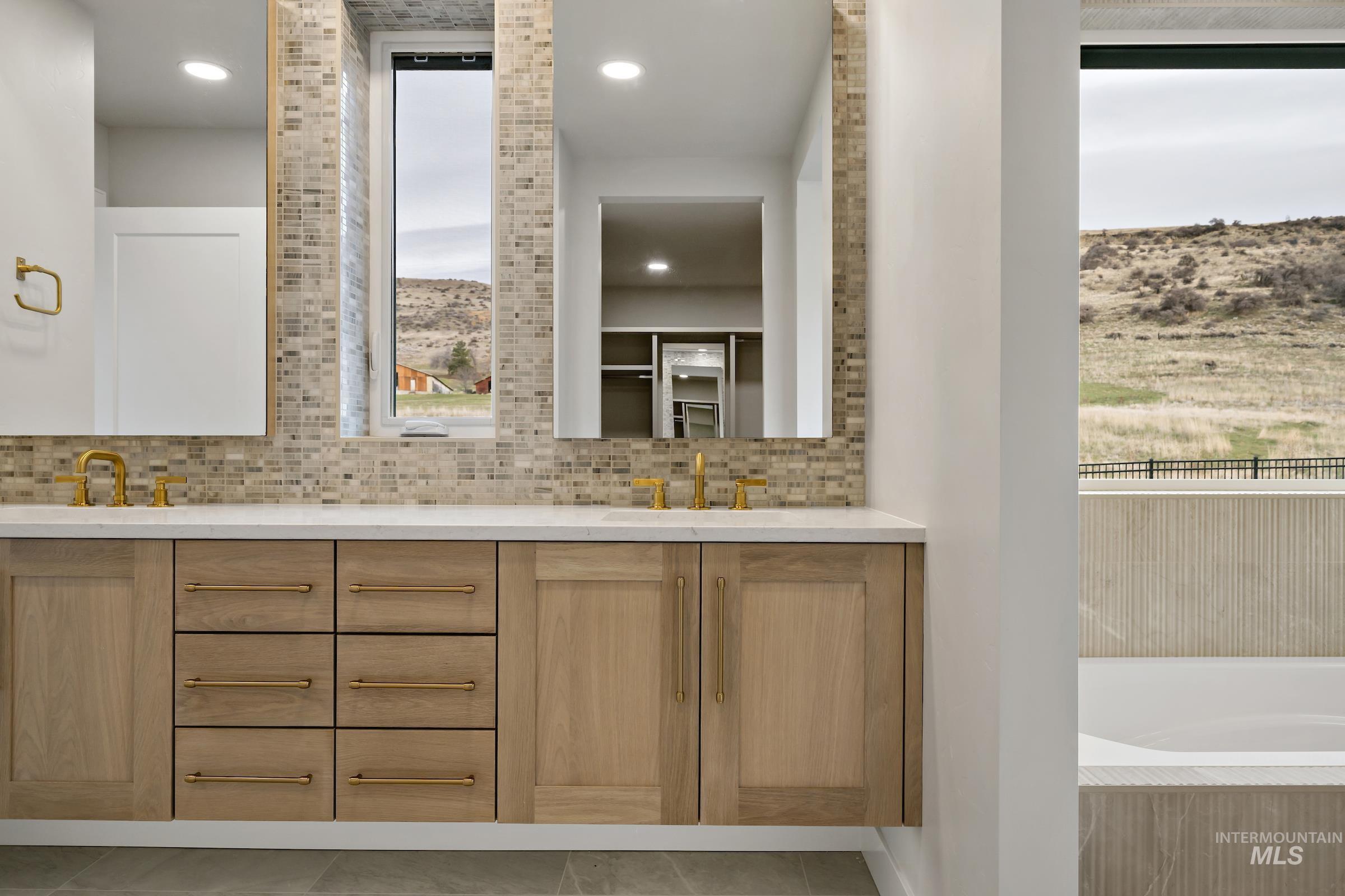 11708 North Rabbitbrush Way Boise, ID 83714 - Photo 20 of 33 Full bath with double vanity, a bath, backsplash, and recessed lighting
