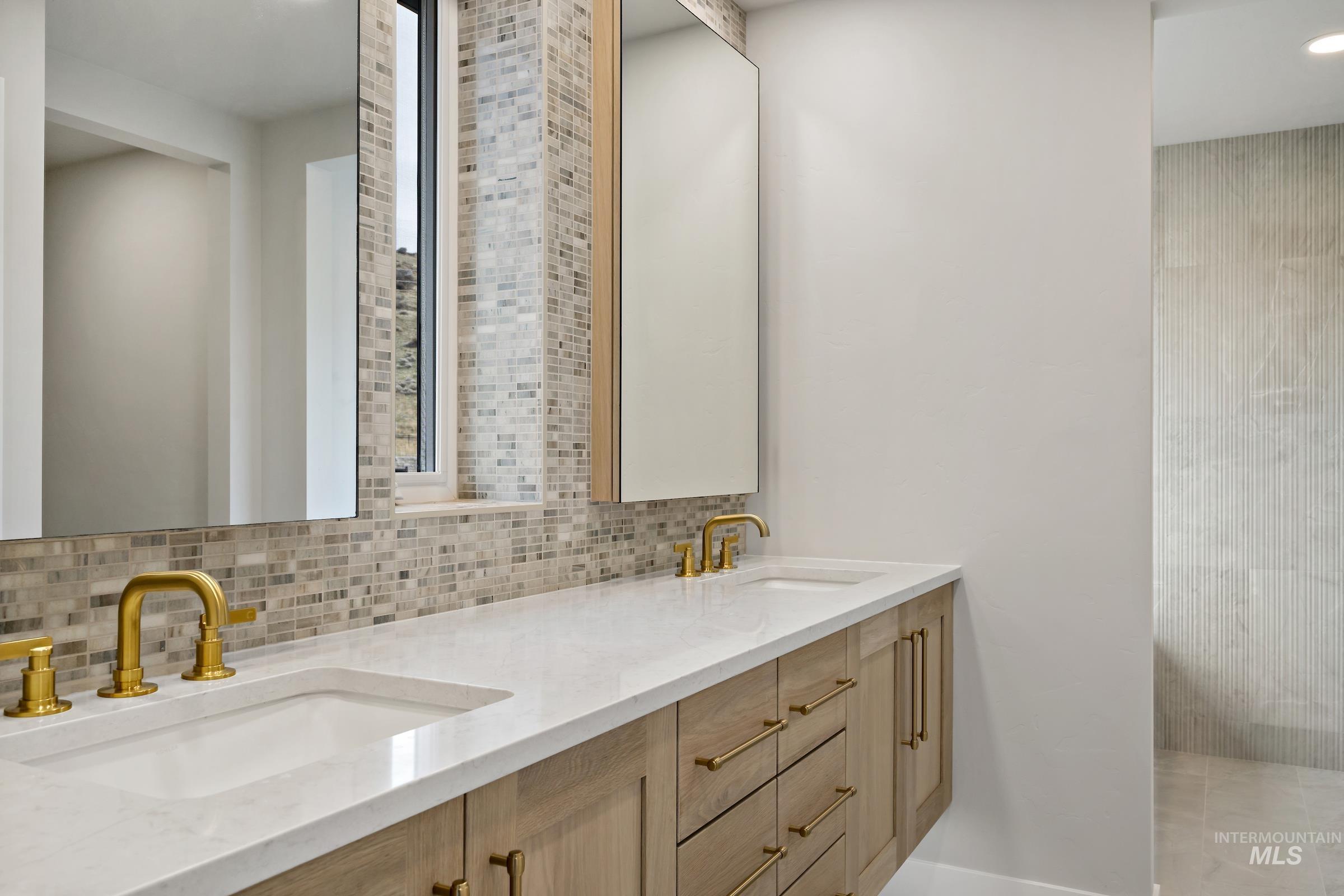 11708 North Rabbitbrush Way Boise, ID 83714 - Photo 21 of 33 Bathroom with double vanity, decorative backsplash, and recessed lighting