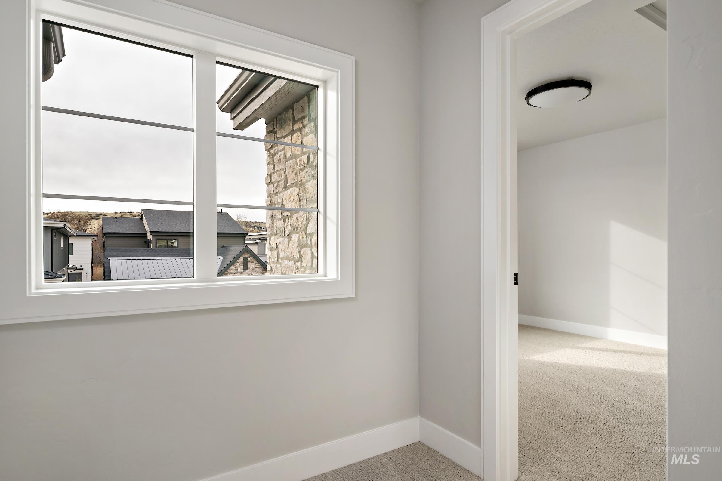 11708 North Rabbitbrush Way Boise, ID 83714 - Photo 25 of 33 Spare room with light carpet and baseboards