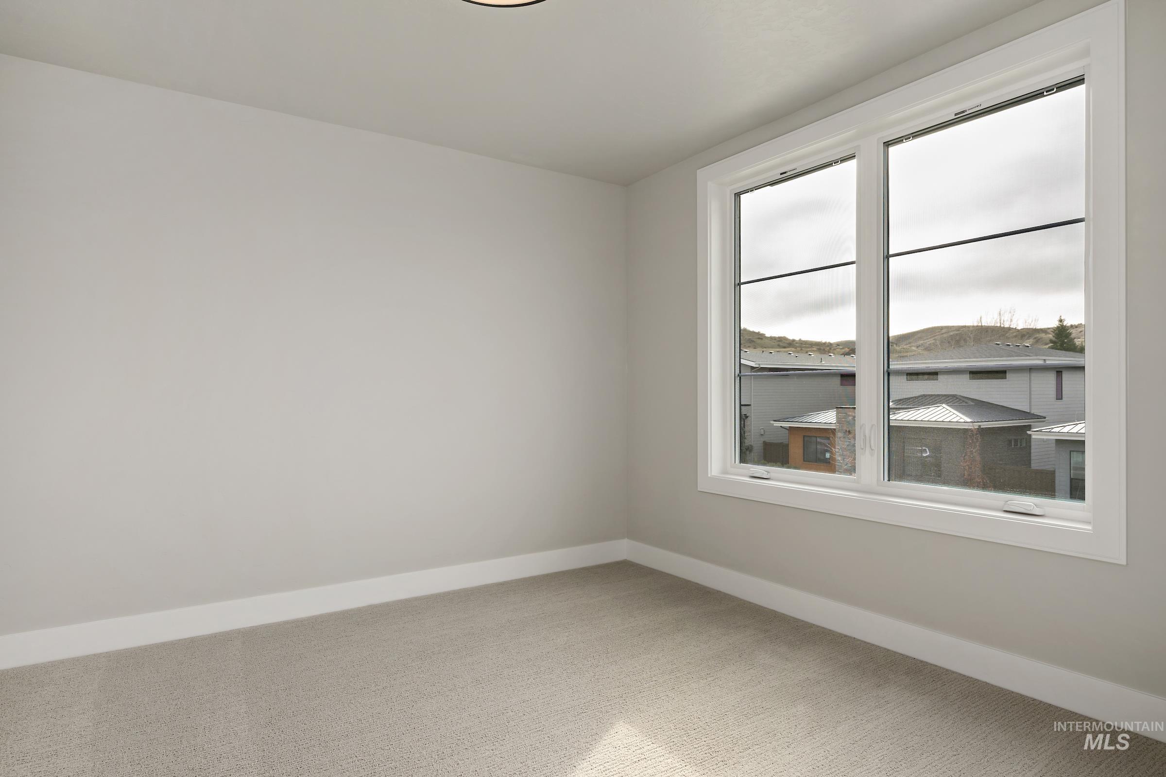 11708 North Rabbitbrush Way Boise, ID 83714 - Photo 26 of 33 Unfurnished room featuring baseboards and carpet floors
