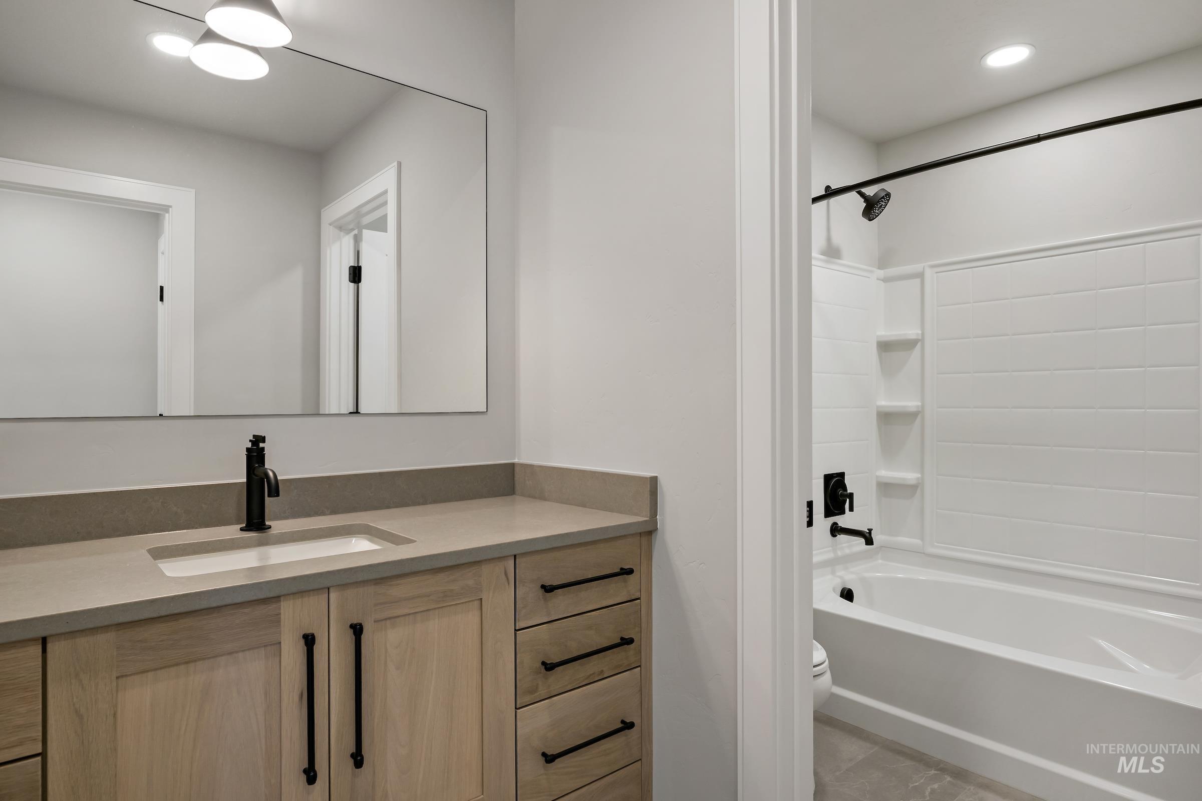 11708 North Rabbitbrush Way Boise, ID 83714 - Photo 27 of 33 Bathroom featuring bathtub / shower combination, vanity, and recessed lighting