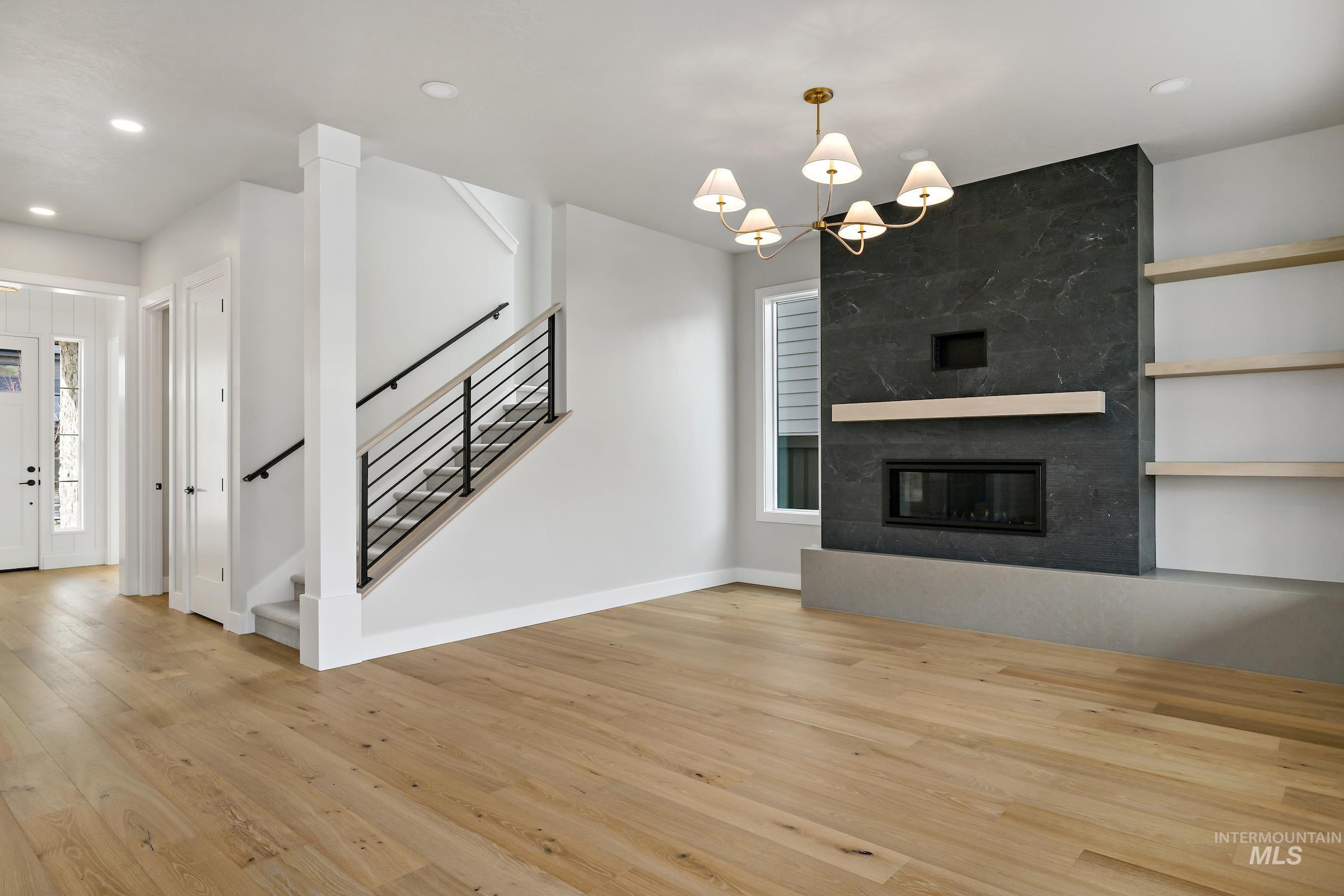 11708 North Rabbitbrush Way Boise, ID 83714 - Photo 8 of 33 Unfurnished living room with stairway, a fireplace, light wood-style floors, recessed lighting, and plenty of natural light