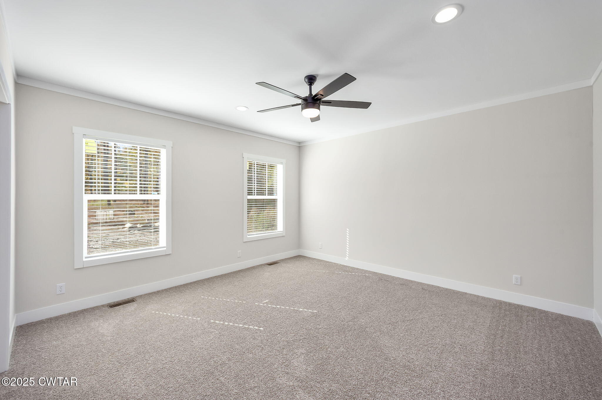 2127 North Royal Street Jackson, TN 38305 - Photo 13 of 26 an empty room with windows and fan