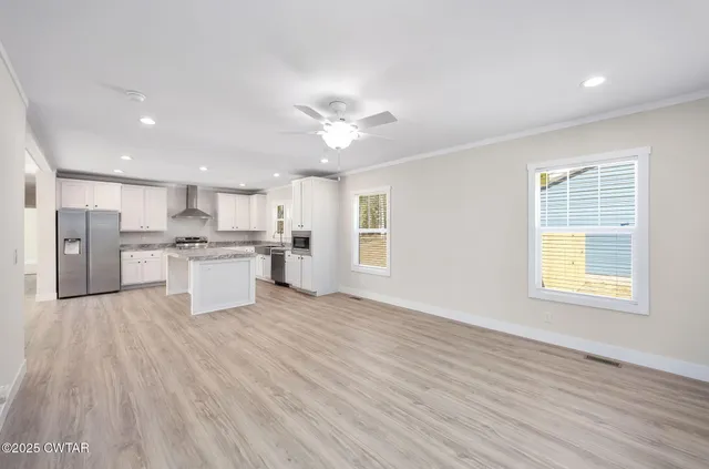 a view of kitchen with wooden floor and window