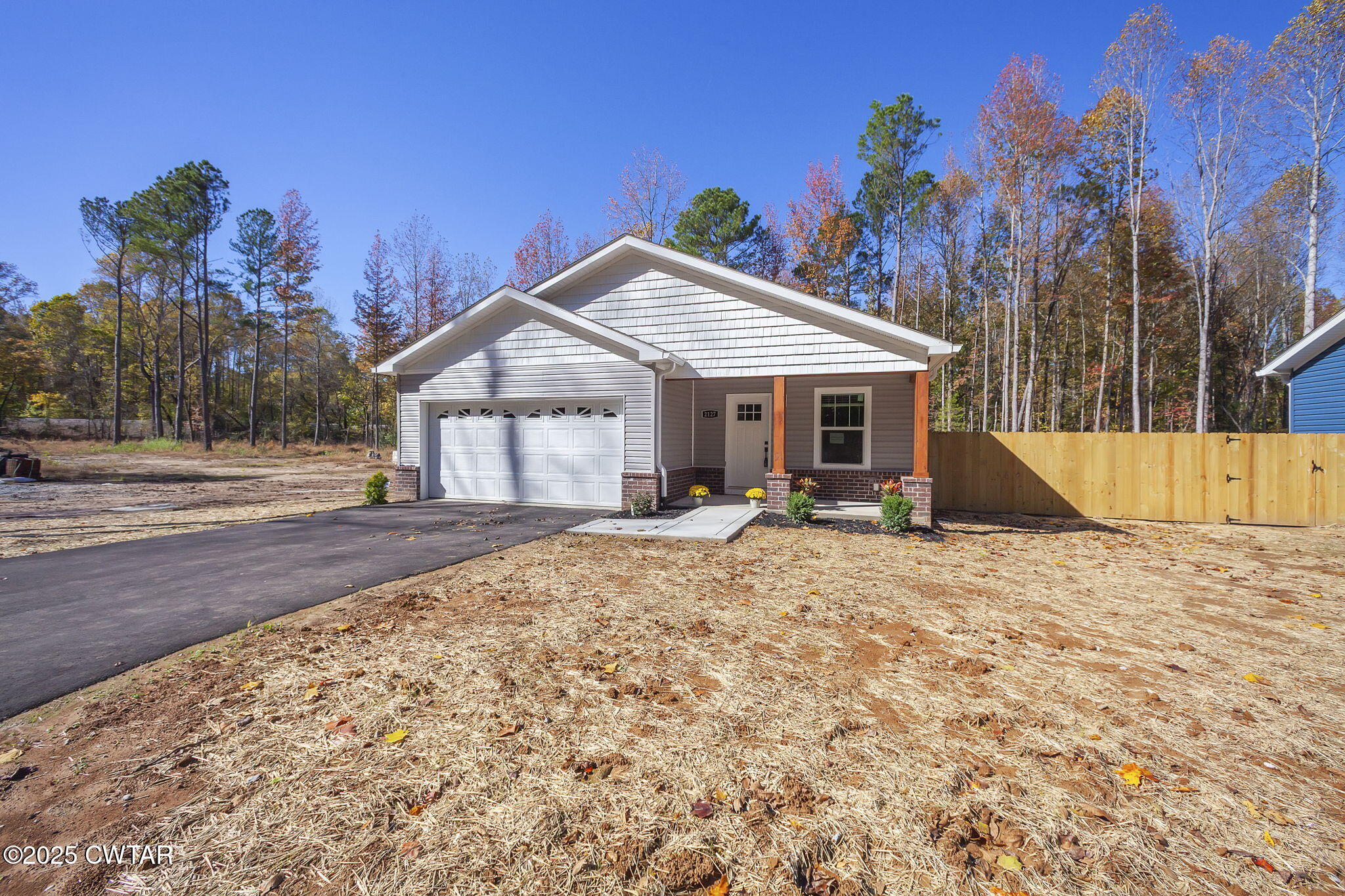 2127 North Royal Street Jackson, TN 38305 - Photo 25 of 26 a front view of a house with a yard and garage