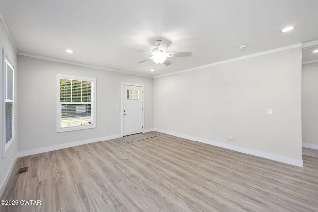 wooden floor in an empty room with a window