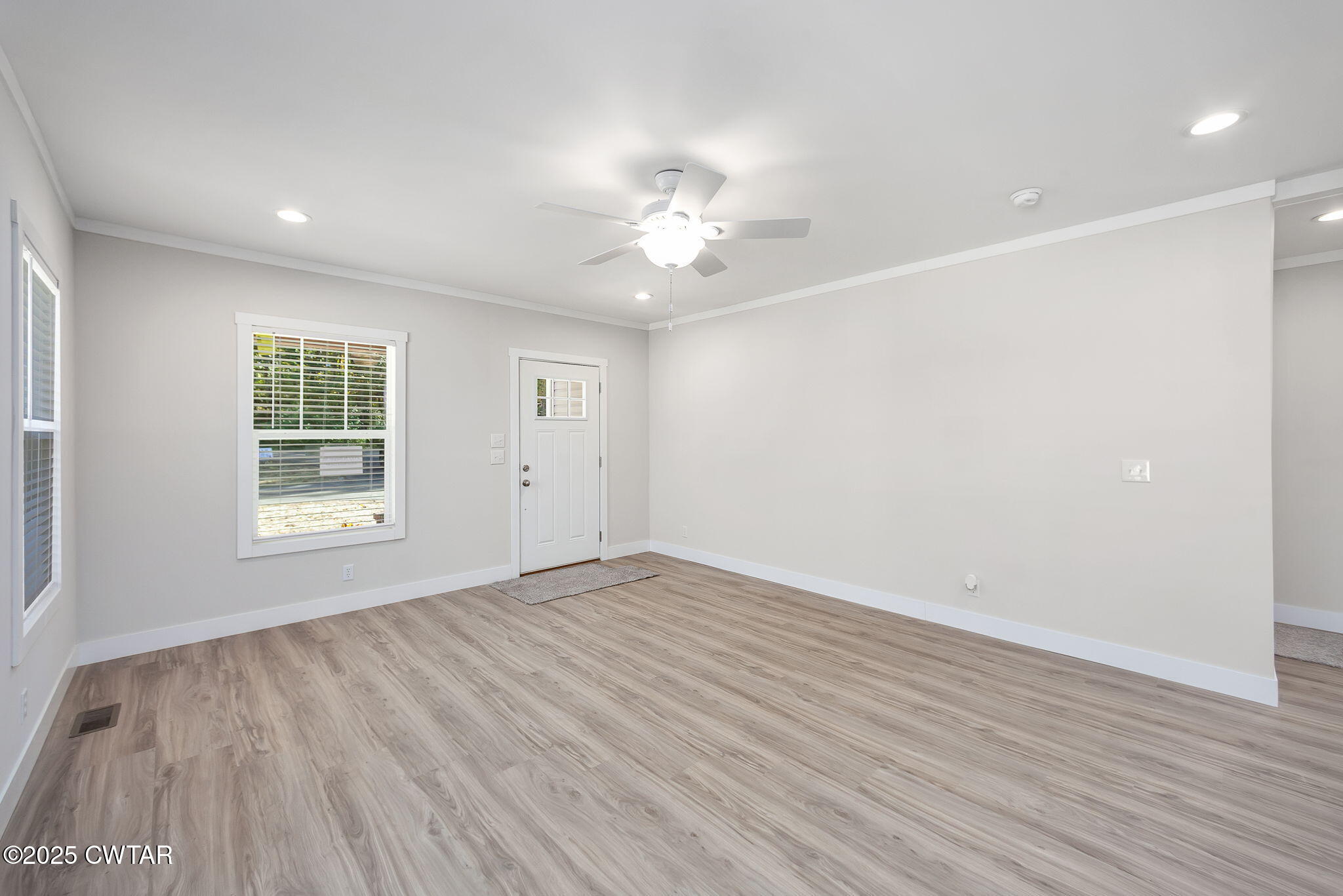 2127 North Royal Street Jackson, TN 38305 - Photo 4 of 26 wooden floor in an empty room with a window