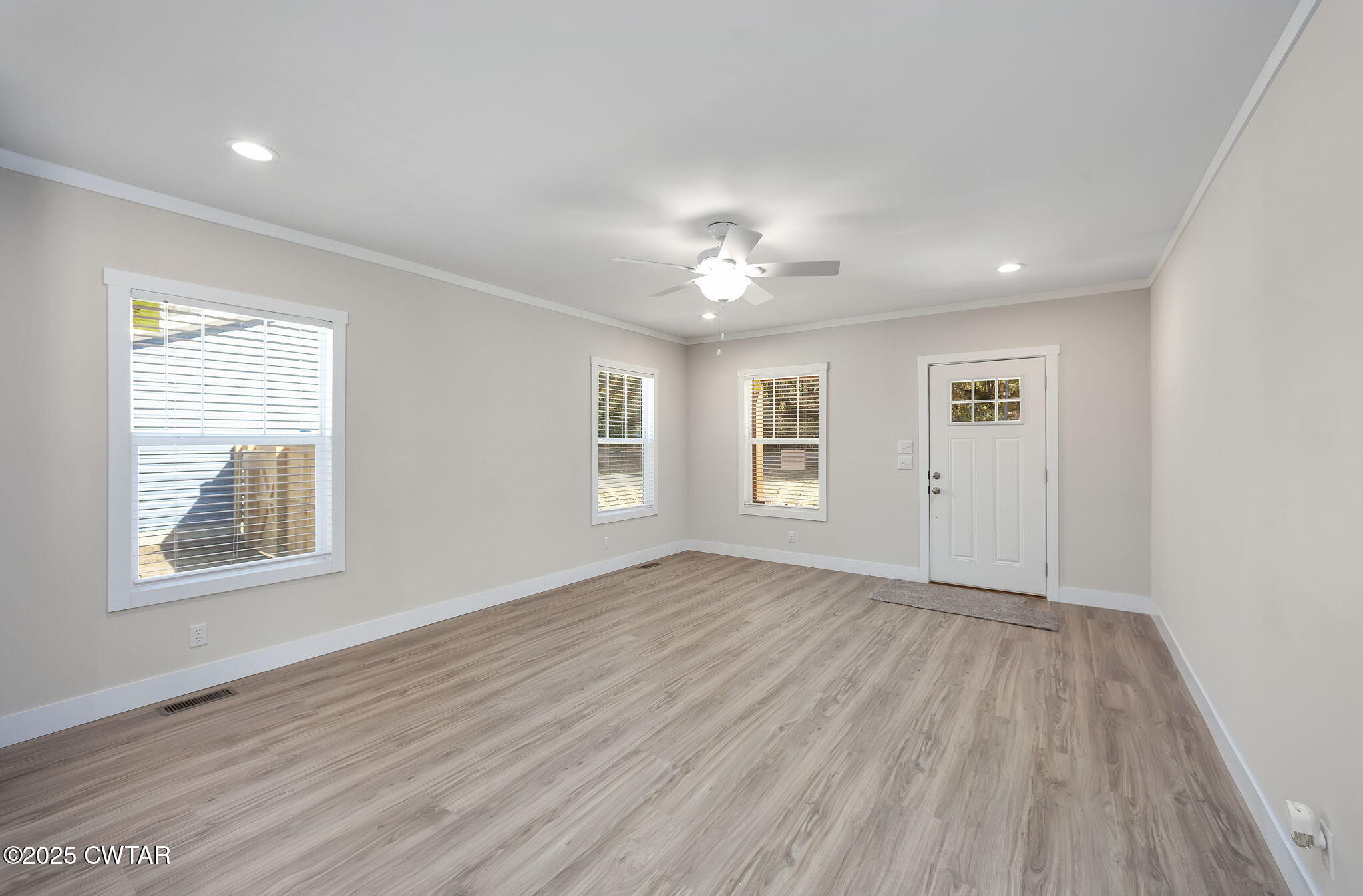 2127 North Royal Street Jackson, TN 38305 - Photo 5 of 26 a view of an empty room with a window and wooden floor