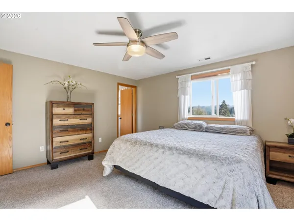 a bedroom with a bed and a ceiling fan