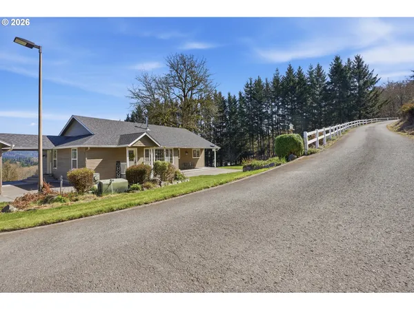 a front view of a house with a yard and street view