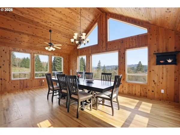 a dining room with furniture window and wooden floor