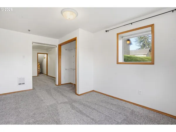 a view of an empty room with closet area