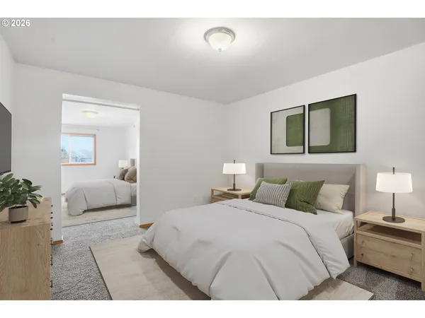 a bedroom with a large bed and a couch