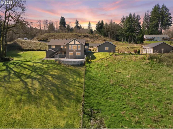 a view of a house with a yard and sitting area