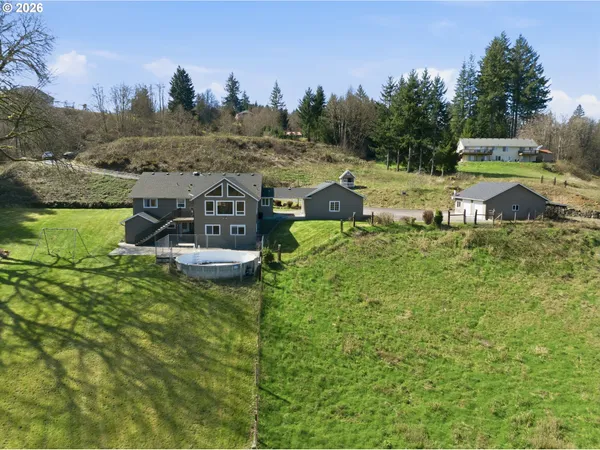 a aerial view of a house with a yard basket ball court and outdoor seating