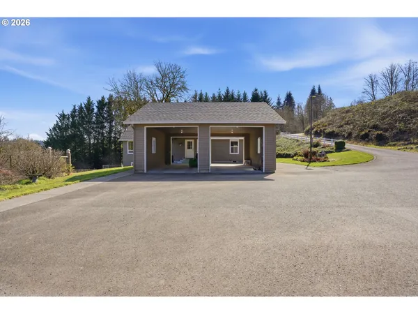 a view of a house with a yard and a garage