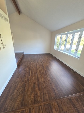 701 Bishops Gate New Lenox, IL 60451 - Photo 12 of 27 wooden floor in an empty room with a window