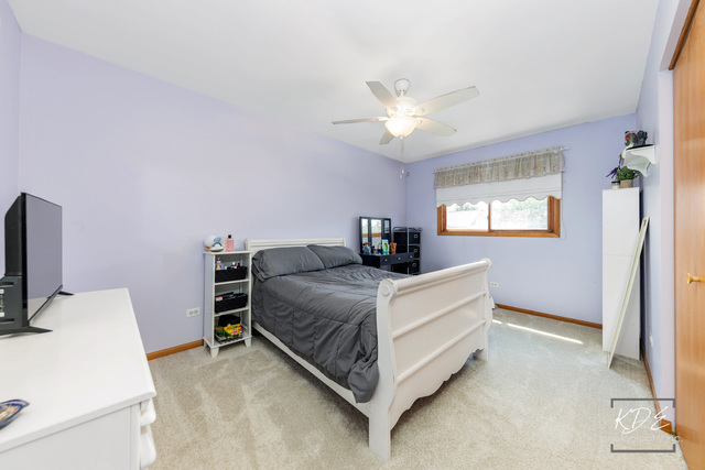 701 Bishops Gate New Lenox, IL 60451 - Photo 16 of 27 a room with a bed and a chandelier