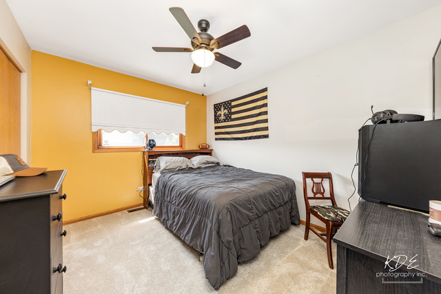 701 Bishops Gate New Lenox, IL 60451 - Photo 19 of 27 a spacious bedroom with a bed and a desk