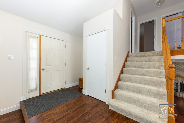701 Bishops Gate New Lenox, IL 60451 - Photo 2 of 27 a view of a hallway with wooden floor and entryway