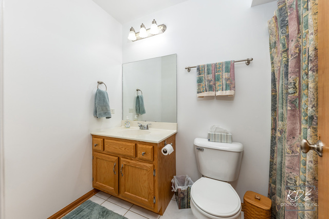 701 Bishops Gate New Lenox, IL 60451 - Photo 22 of 27 a bathroom with a toilet a sink and mirror