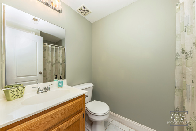 701 Bishops Gate New Lenox, IL 60451 - Photo 23 of 27 a bathroom with a granite countertop sink a toilet and a mirror