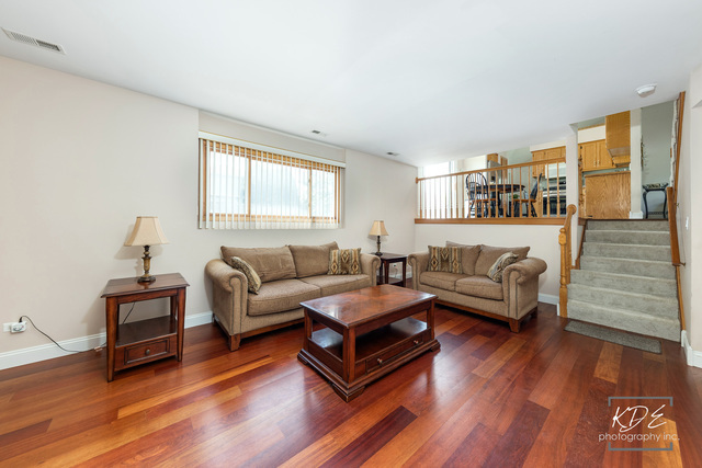 701 Bishops Gate New Lenox, IL 60451 - Photo 6 of 27 a living room with furniture and a wooden floor