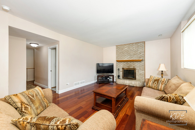 701 Bishops Gate New Lenox, IL 60451 - Photo 10 of 27 a living room with furniture and a fireplace