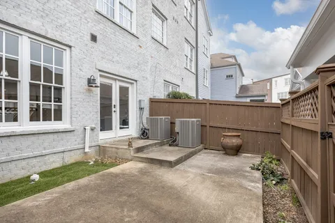 a view of a house with sitting area and potted plants