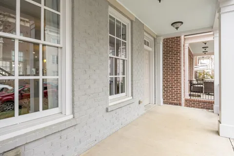 wooden floor in an empty room with a kitchen