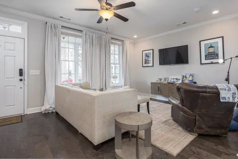 a kitchen with stainless steel appliances kitchen island granite countertop a stove a refrigerator a kitchen island a sink cabinets and a refrigerator