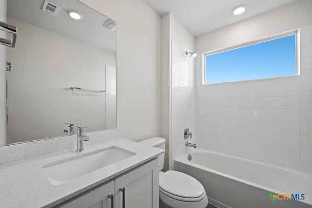 a bathroom with a sink a toilet and a bathtub