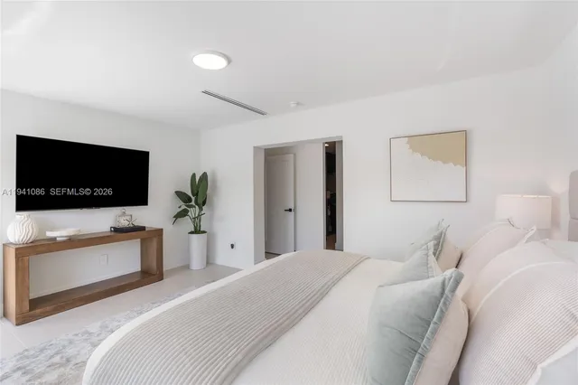 a bedroom with a flat screen television and a bed