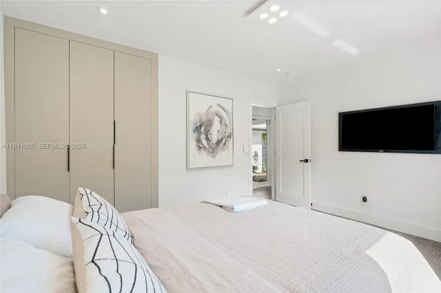 a bedroom with a bed and a flat screen tv