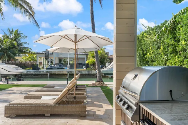 a view of a patio with a table and chairs
