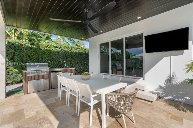 a view of an outdoor dining space with a table and chairs