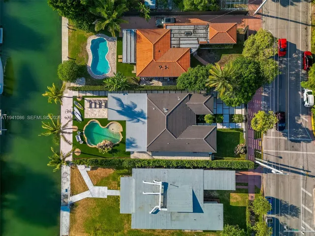 an aerial view of house with swimming pool and outdoor seating