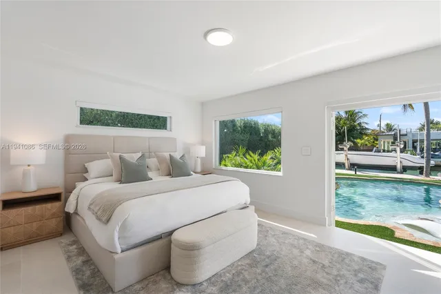 a bed room with a bed and a large window