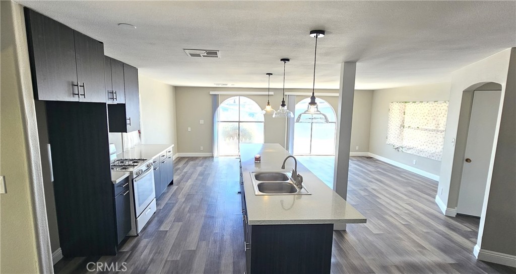 9800 Base Line Road, Unit 82 Alta Loma, CA 91701 - Photo 15 of 28 a kitchen with sink refrigerator and wooden floor