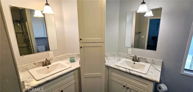 a bathroom with a sink double vanity and a mirror