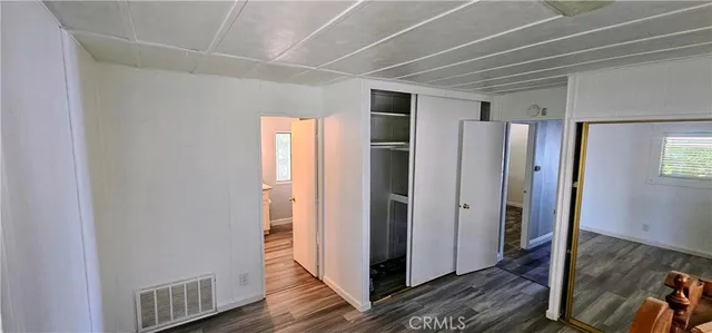 a view of hallway with wooden floor