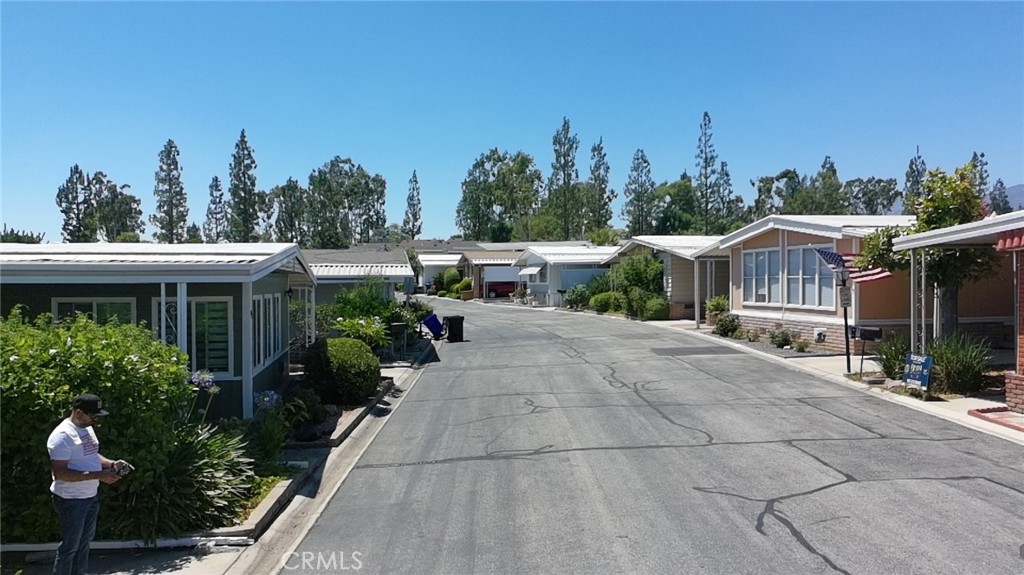 9800 Base Line Road, Unit 82 Alta Loma, CA 91701 - Photo 27 of 28 a view of house with outdoor seating and green space