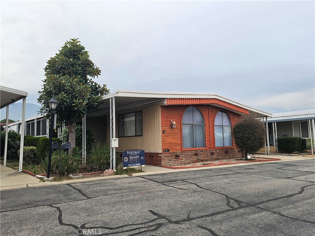 9800 Base Line Road, Unit 82 Alta Loma, CA 91701 - Photo 9 of 28 a front view of a house with a yard