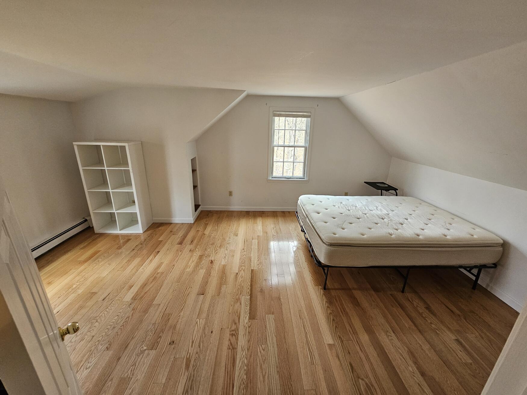 3098 State Highway Wellfleet, MA 02667 - Photo 11 of 13 a view of a bedroom with wooden floor and front door