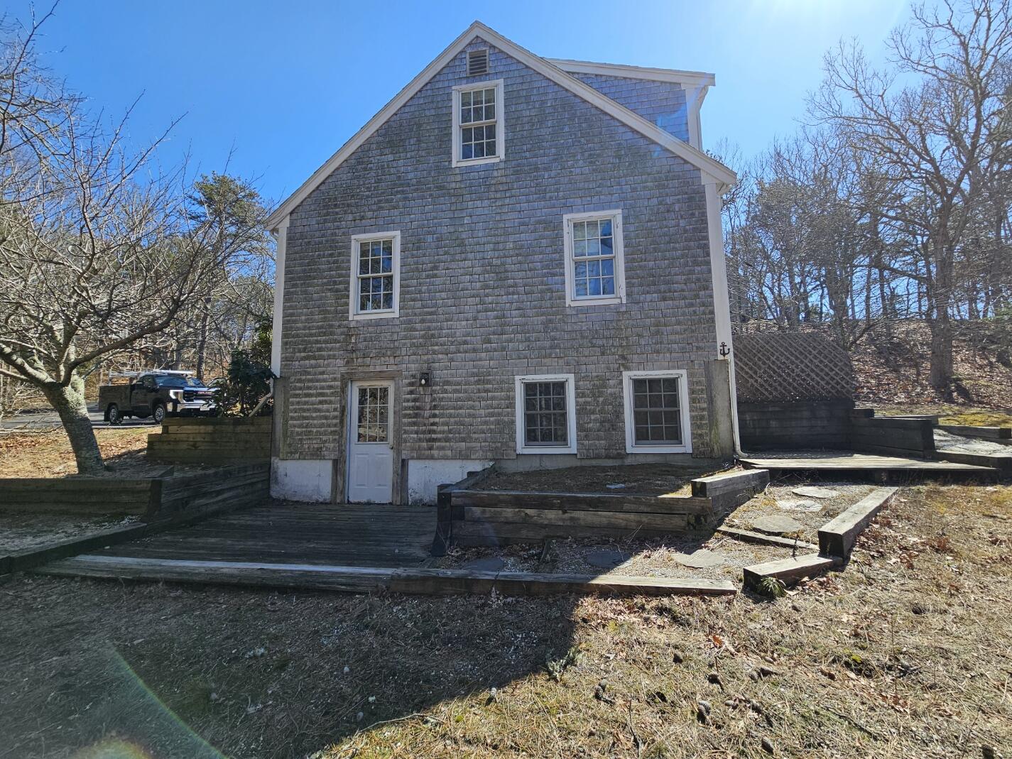 3098 State Highway Wellfleet, MA 02667 - Photo 4 of 13 a front view of a house with a yard