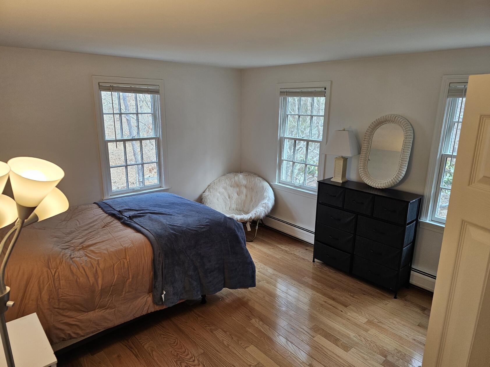 3098 State Highway Wellfleet, MA 02667 - Photo 6 of 13 a bedroom with a bed and wooden floor