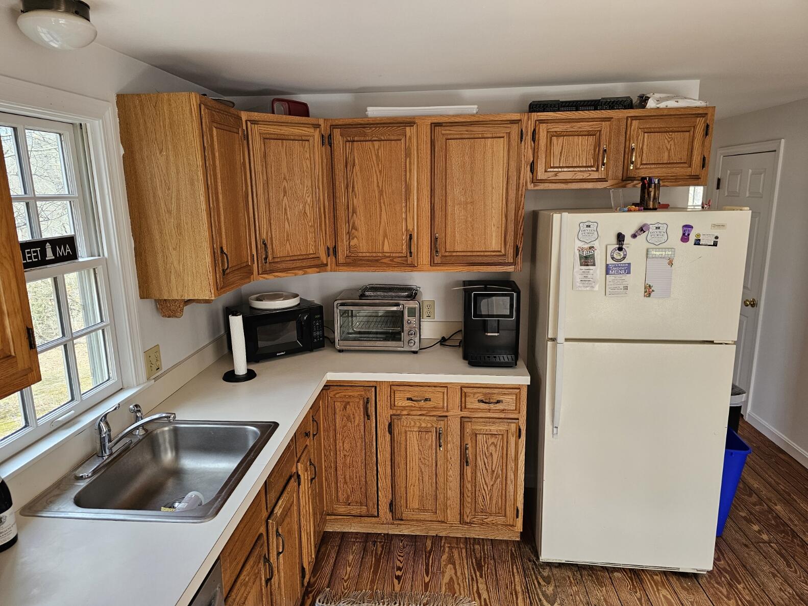 3098 State Highway Wellfleet, MA 02667 - Photo 7 of 13 a kitchen with a refrigerator a stove a sink and a counter space